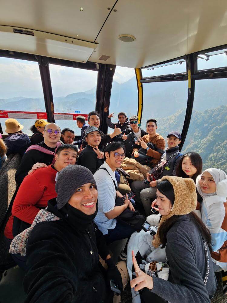 MedicalMet team riding the Fansipan cable car above the mountains in Sapa, Vietnam during the 2025 company trip
