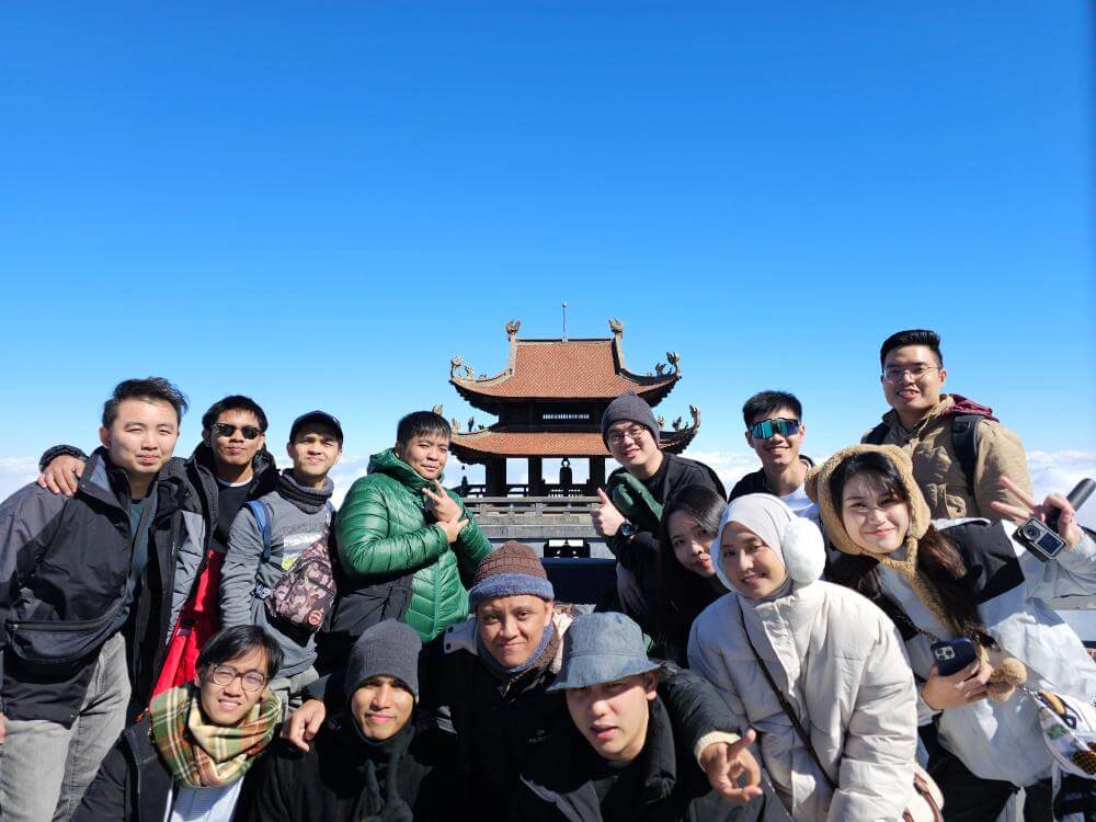 MedicalMet team group photo at the Fansipan summit temple in Sapa, Vietnam